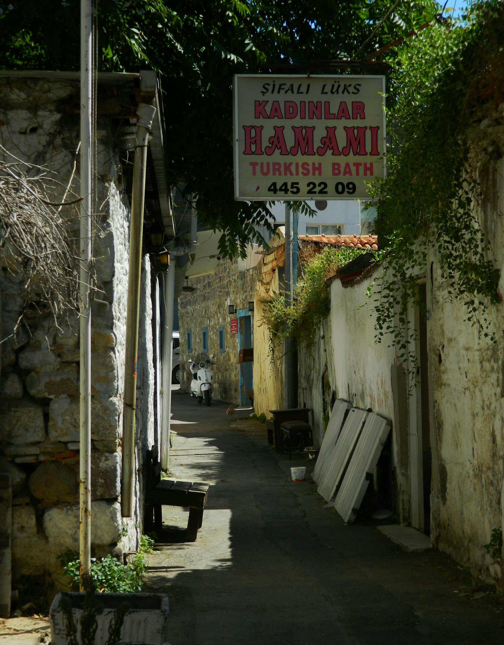 Picturesque alley with Turkish bath sign in a traditional village.